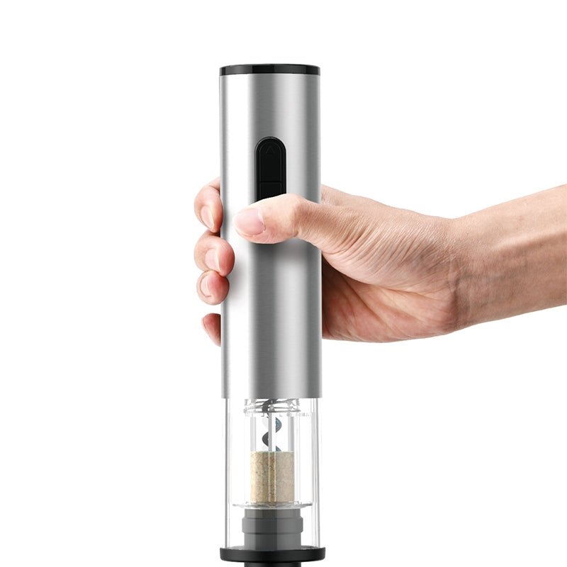 Hand using electric wine opener